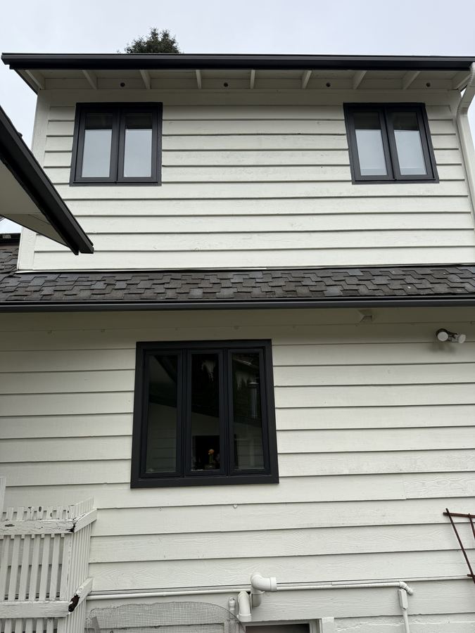 New black-framed windows on a two-storey home