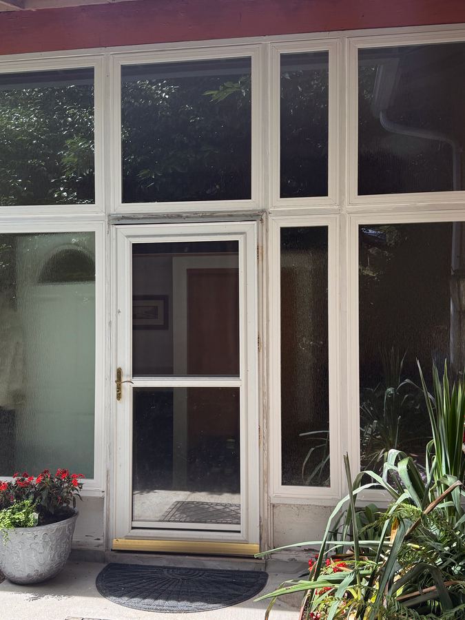 Same entry surround after new insulated vinyl windows with tempered glass