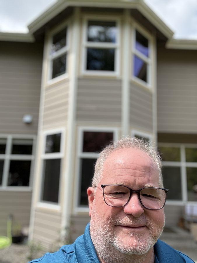 Steve White of Mach 4 Homes Remodels in front of a completed window job
